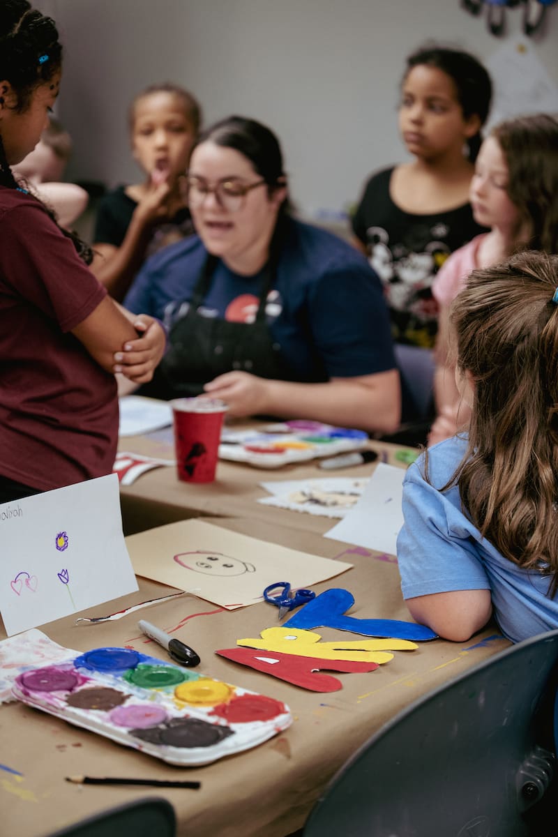 Art camp teacher lectures young students