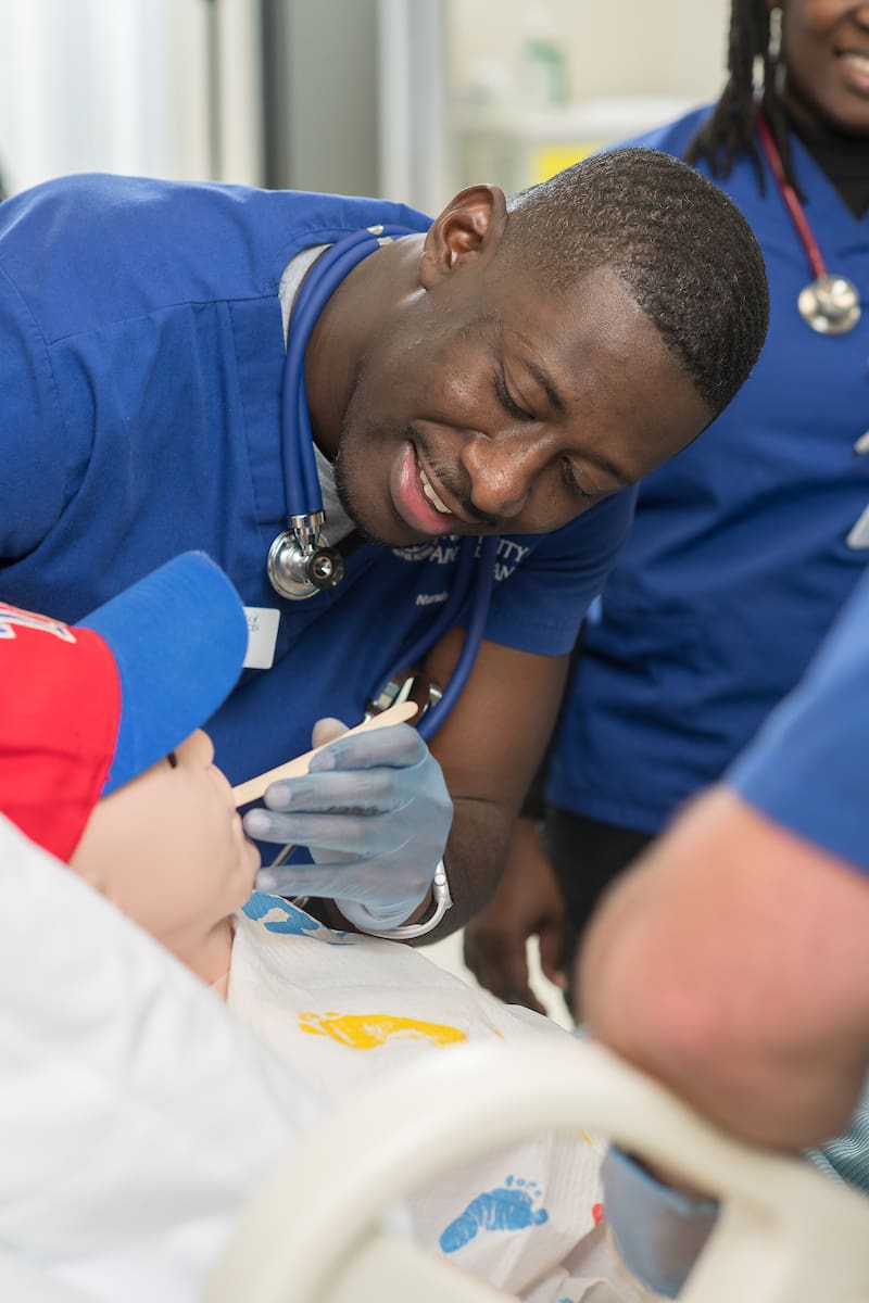 ASN Nurse examines manikin