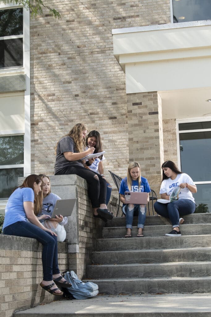 Students studying outside of bonzel hall