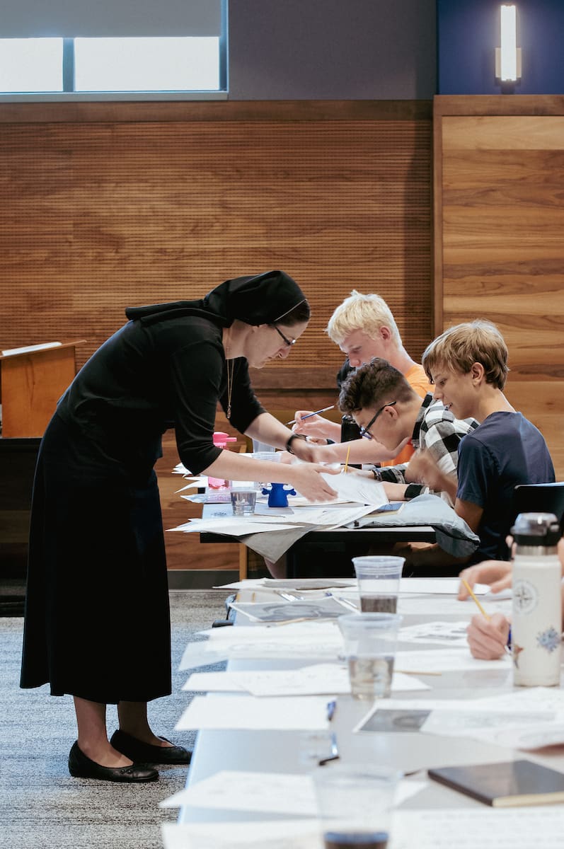 Nun instructing theology camp campers