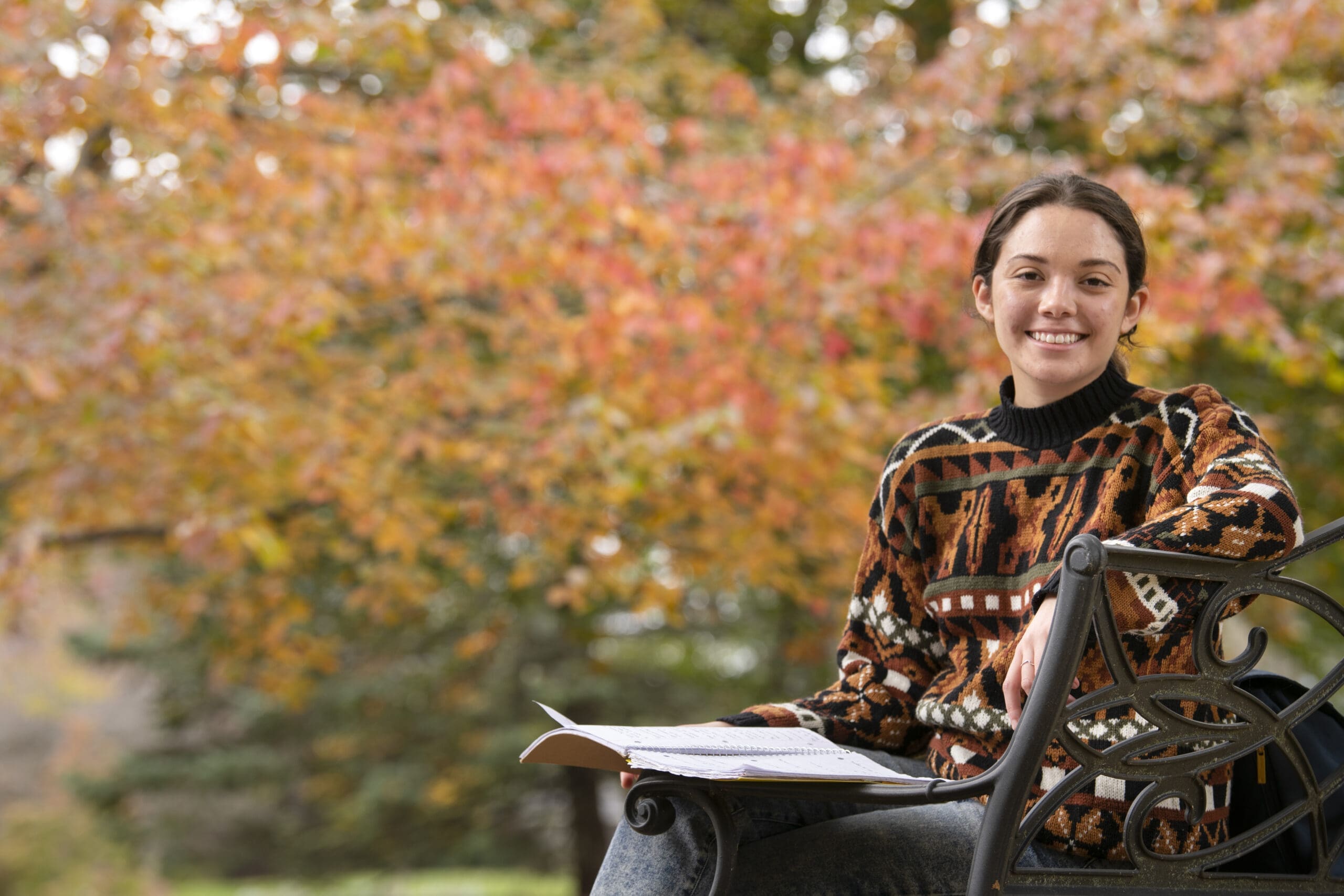 Student studying outside on a nice fall day on campus. 