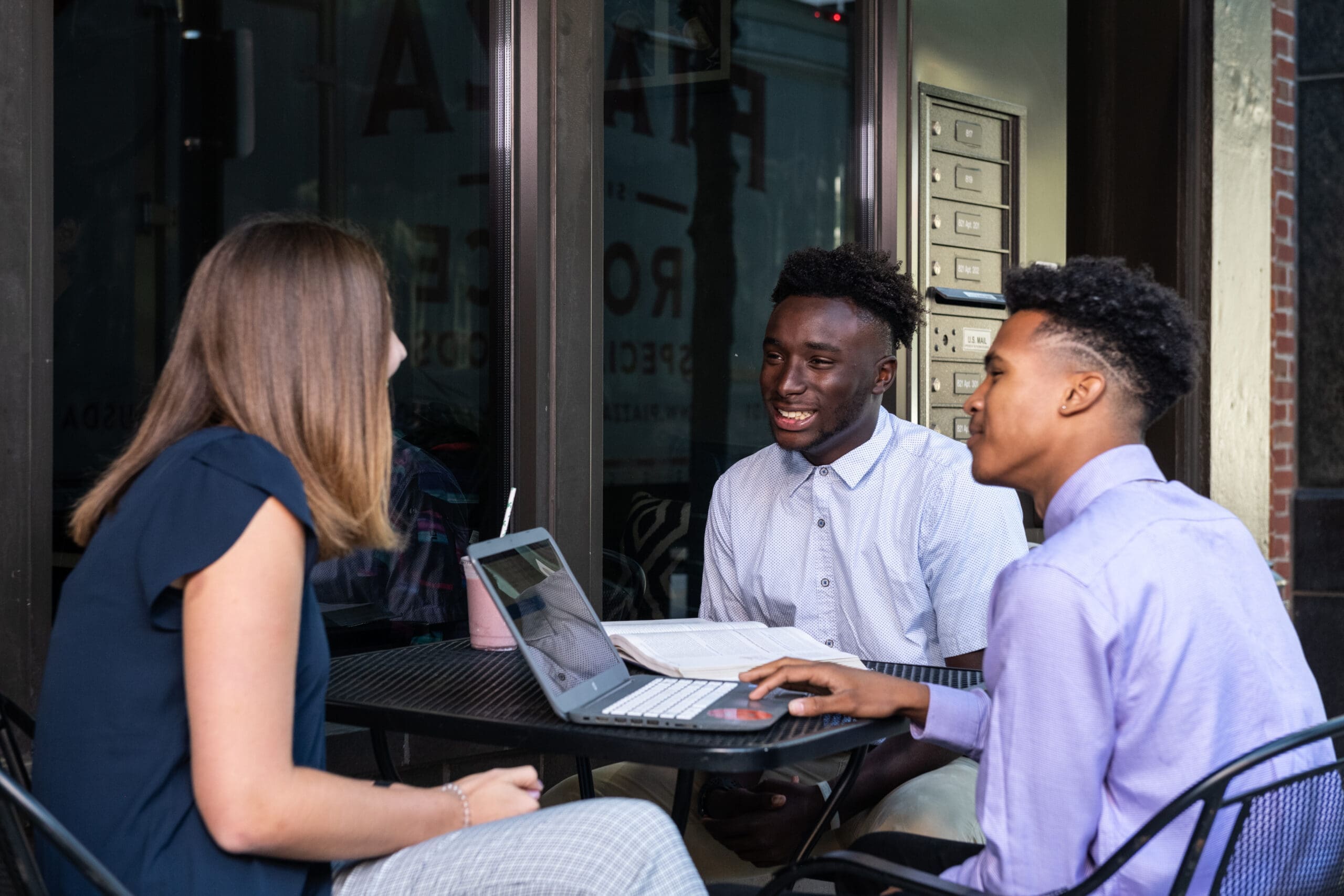 business students sitting outside downtown