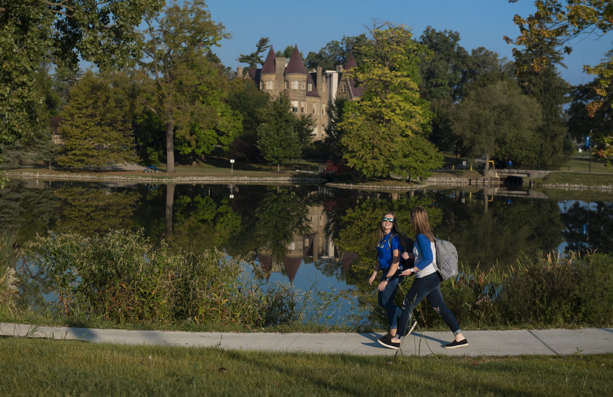 Students walking along a scenic path on campus