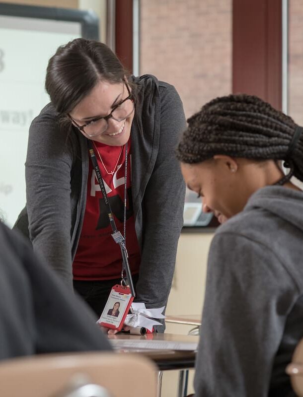 Teacher looks at student's work