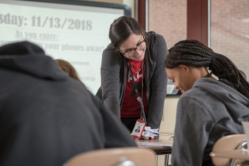 Teacher looks at student's work