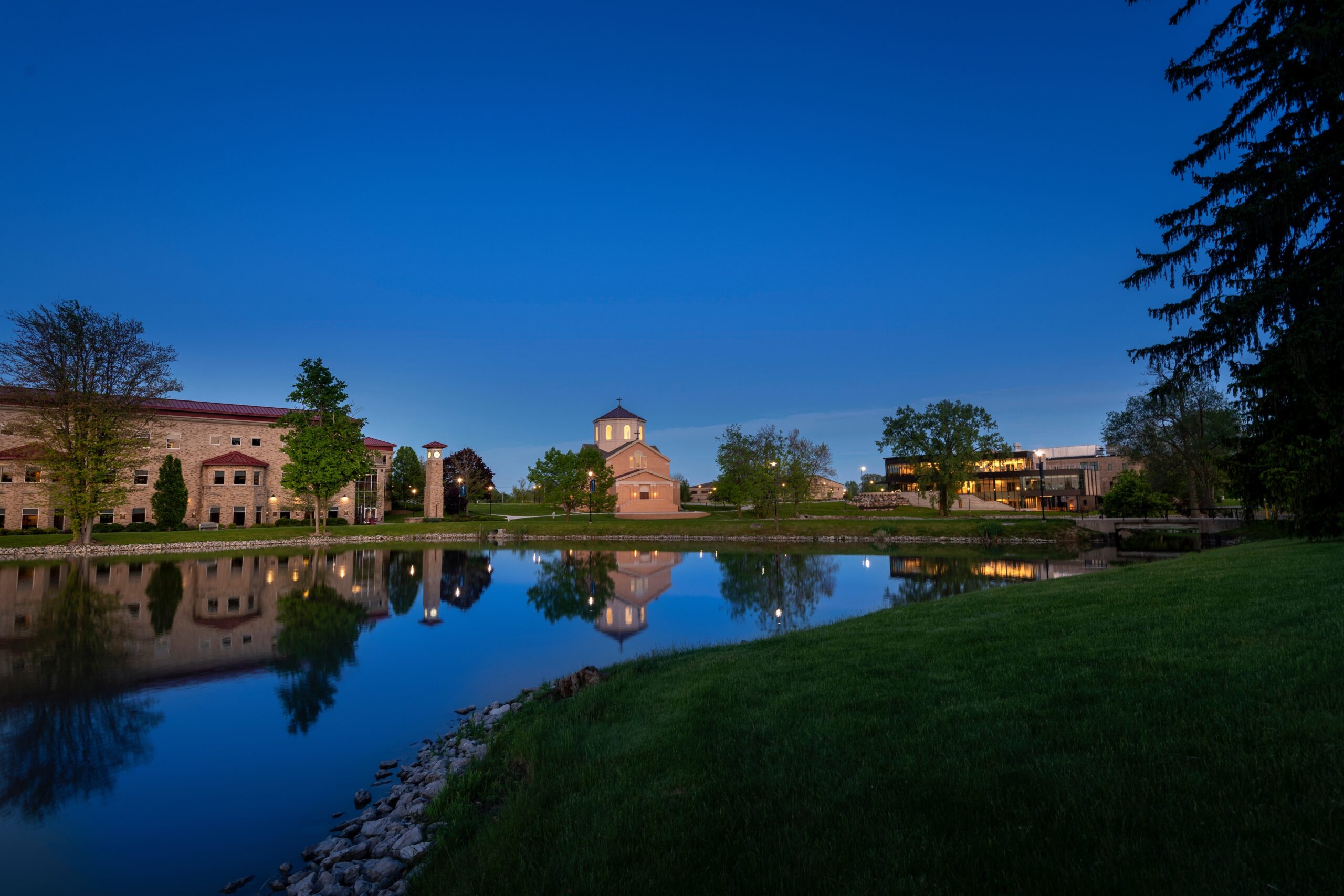 Wide view of campus including chapel and Achatz hall from across Mirror Lake