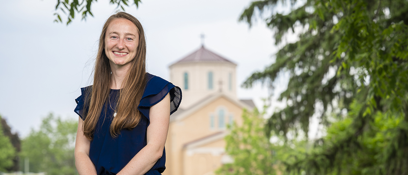 Portrait of runner named Cadence Faurote with the St. Francis Chapel in the background