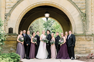 Shawn and Olivia Ryan and their wedding party standing in front of Brookside Manor