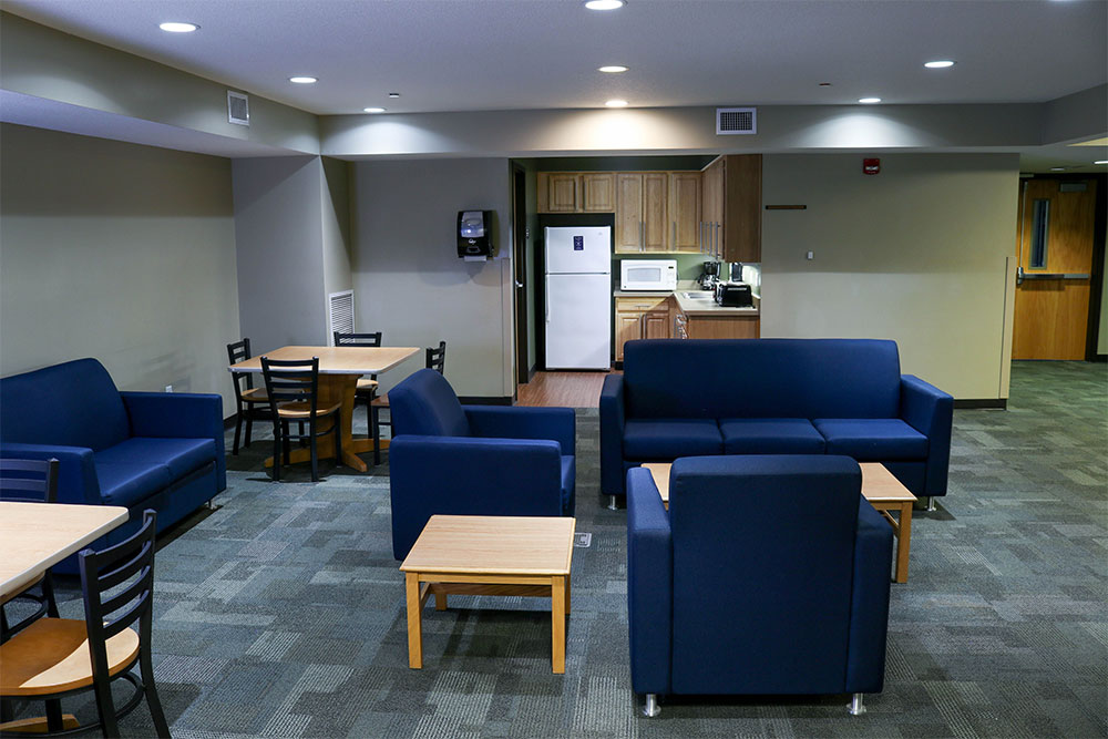 Each floor in Clare Hall has a common area with tables, chairs, couches, and a flat screen tv